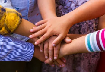 Photo of children's hands in a circle
