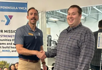 Joey Belanger and Ryan Amiot shaking hands in the wellness center.
