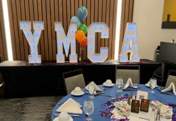 YMCA marquee letters at a dinner event