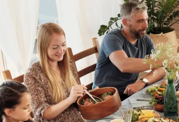 A photo of a family sharing a meal at a table