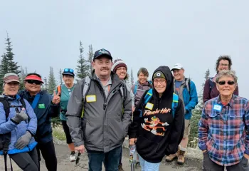 A group of adults walking for exercise and companionship in the outdoors.