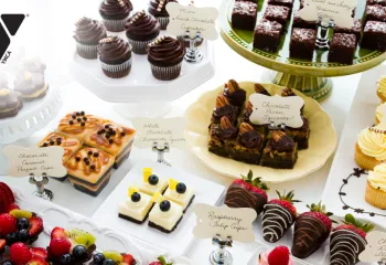 A stock image of a variety of desserts on a display table.