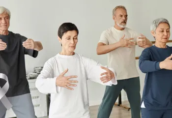 A few men and women of different ages doing gentle exercise.