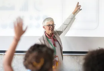 A person raising their hand at a presentation.
