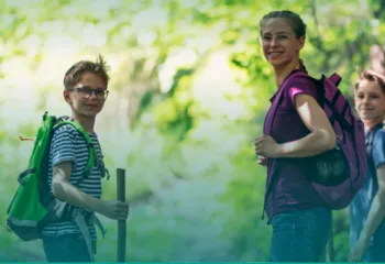 An image of middle school kids hiking in the woods