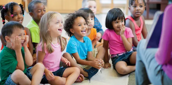 Preschool aged children sitting at story time.