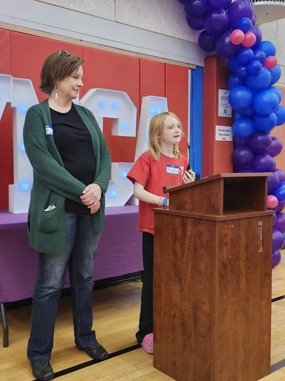Mother and daughter giving a presentation at an event.