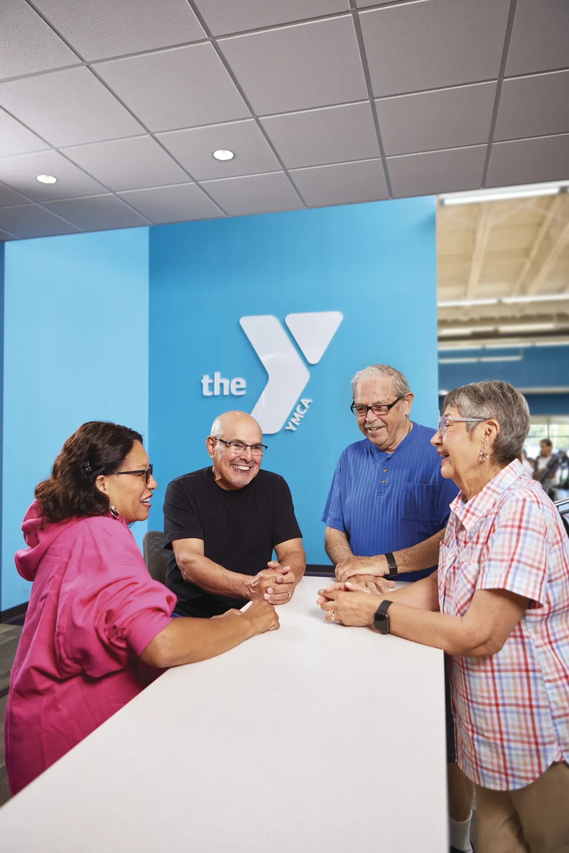 A few community members talking to a YMCA Member Services Representative at a YMCA.