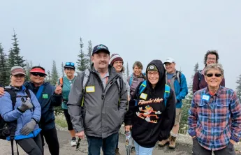 A group of adults walking for exercise and companionship in the outdoors.