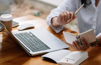 A woman working at her laptop.