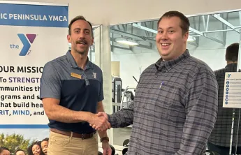 Joey Belanger and Ryan Amiot shaking hands in the wellness center.