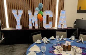 YMCA marquee letters at a dinner event