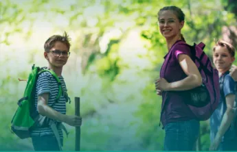An image of middle school kids hiking in the woods