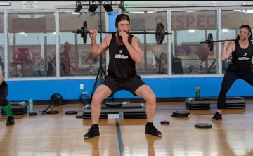 Three Bodypump instructors leading group exercise class