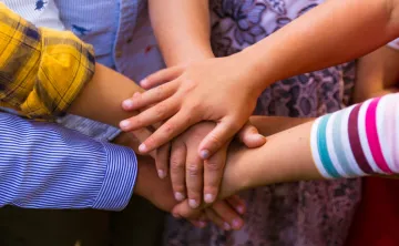 Photo of children's hands in a circle