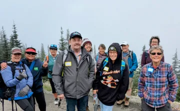 A group of adults walking for exercise and companionship in the outdoors.