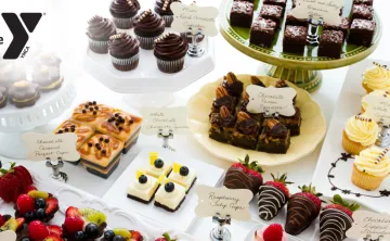 A stock image of a variety of desserts on a display table.