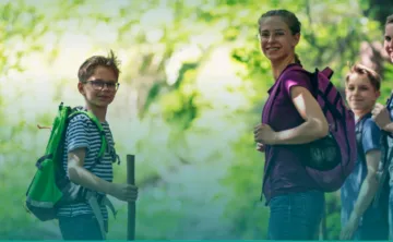 An image of middle school kids hiking in the woods